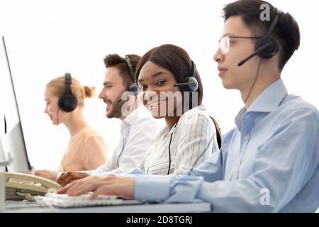 Concept de télécommunications. Opérateurs d'assistance positifs vendant des services ou des biens par le biais de la téléphonie VoIP dans un centre d'appels Banque D'Images