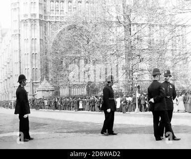 Des policiers et une file d'attente à la tour Victoria, au Parlement de Londres, au début des années 1900 Banque D'Images