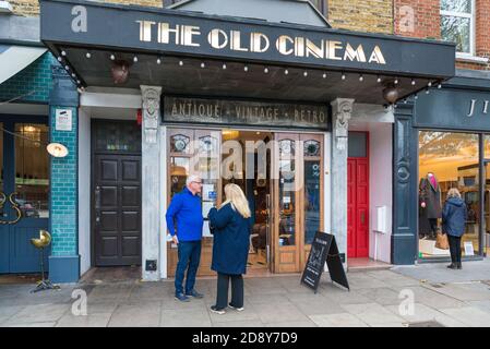 Couple d'âge mûr debout à l'extérieur de la boutique d'antiquités Old Cinema, Chiswick High Road, Londres, Angleterre, Royaume-Uni Banque D'Images