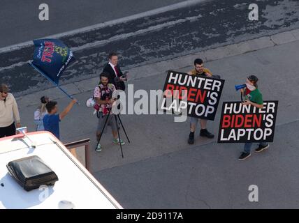 Austin, TX USA 30OCT20: Les partisans du président Donald Trump bloquent un bus de campagne Biden-Harris dans le parking du bureau AFL-CIO au centre-ville d'Austin. Deux signes font référence à un reportage infondé de preuves incriminantes trouvées sur un ordinateur appartenant au fils du rival de Trump, le candidat démocrate à la présidence Joe Biden. Banque D'Images