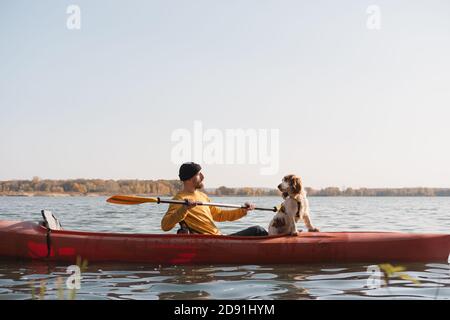 Kayak avec les chiens : homme ramer un bateau sur le lac avec son épagneul. Repos actif et aventures avec les animaux de compagnie, en faisant du canoë avec le chien Banque D'Images