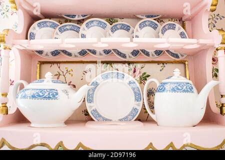 Délicat ensemble de thé en porcelaine blanche avec une sélection de soucoupes, tasses et théières Banque D'Images