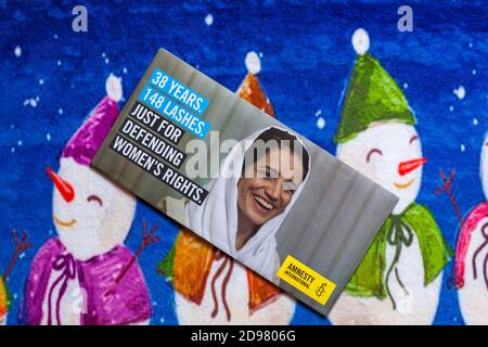 Poster sur le tapis de Noël - appel à la charité, Amnesty International 38 ans 148 coups de fouet pour défendre les droits des femmes Banque D'Images