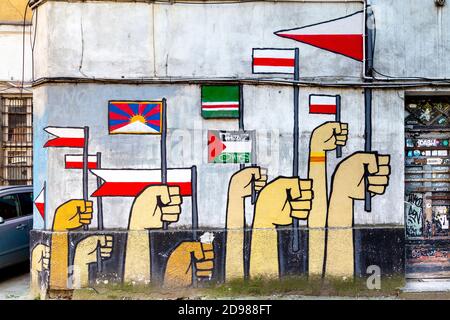 Fresque des mains tenant des drapeaux dans une cour à la baisse, 11 rue Listopada dans le quartier branché de Praga, Varsovie, Pologne Banque D'Images