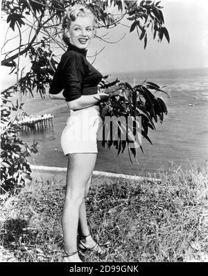 1951 , Malibu Beach , CA , États-Unis : L'actrice MARILYN MONROE ( 1926 - 1962 ) , toujours pubblicity , renard du XXe siècle , photo de Frank Powolny .- MER - MARE - PIN UP - LEGGY POSE - SHORT - SANDALS - SANDALI - PIN-up - jambes - gambe - sourire - sorriso -- - Archivio GBB Banque D'Images