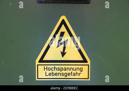 Signe avec un flash et texte allemand Vorsicht Hochspannung, en anglais haute tension danger à la vie Banque D'Images