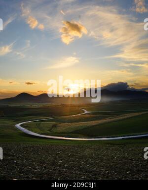 Route sinueuse dans une vallée rurale de la Sicile à la coucher de soleil Banque D'Images