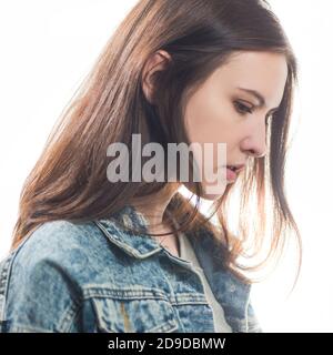 jeune femme timide brunet portrait en jean veste isolée dessus arrière-plan blanc Banque D'Images