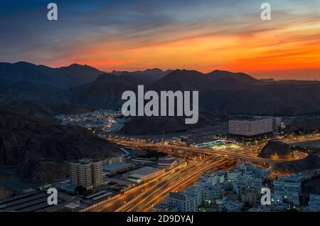 Magnifique ciel orange au-dessus de la ville de Muscat dans la soirée. Prise de vue depuis une colline. Banque D'Images