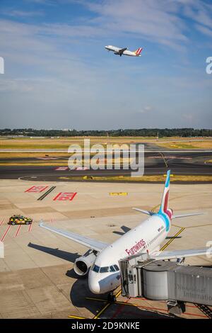 Düsseldorf, Rhénanie-du-Nord-Westphalie, Allemagne, Eurowings avion est garée à la porte, l'aéroport international de Düsseldorf, DUS, un Germanwings décollage à l'arrière. Banque D'Images