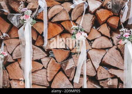 Détail, mariage, pile de bois, rondins décorés de petits bouquets de fleurs Banque D'Images