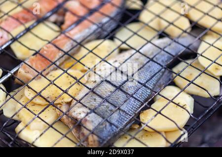 Truite et pommes de terre sur un grill Banque D'Images