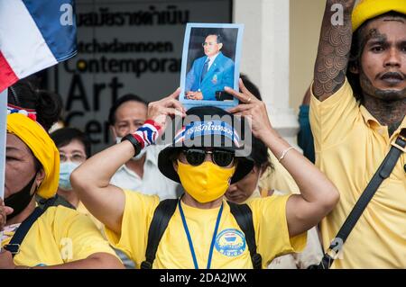 Une femme royaliste thaïlandaise portant un masque tient un portrait du Roi Bhumibol (Rama IX) pendant la manifestation. Les partisans royalistes thaïlandais du roi Maha Vajiralongkorn protestent pour exiger la protection de la monarchie tandis que les manifestants pro-démocratie se réunissent au Monument de la démocratie. Banque D'Images