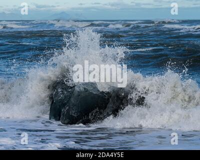 Roche en train d'être éclaboussé par des vagues à Diamond Beach, Hornafjorour, région de l'est, Islande Banque D'Images