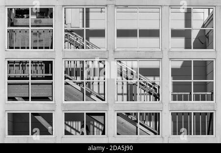 Escalier visible à travers la grille de fenêtres carrées ouvertes Banque D'Images