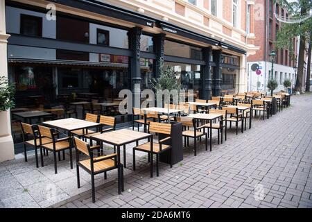 Hanovre, Allemagne. 10 novembre 2020. Des chaises et des tables vides se trouvent devant un restaurant dans le centre-ville. Les gouvernements fédéral et des États ont décidé d'un verrouillage partiel en raison de la pandémie de Corona. Les restaurants, bars et pubs doivent rester fermés. Credit: Julian Stratenschulte/dpa/Alay Live News Banque D'Images