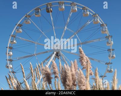 Roue de ferris blanche vide devant le ciel bleu Banque D'Images