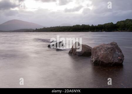 Pierres dans l'eau au Loch Lomond, Écosse Banque D'Images