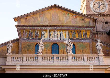 Façade de Santa Maria notre Dame de Trastevere avec des statues sculptées de papes et d'apôtres, mosaïques dorées dans le quartier touristique de Trastevere à Rome Banque D'Images