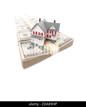 Petite maison sur ligne de Hundred Dollar Bill Stacks isolé sur un fond blanc. Banque D'Images