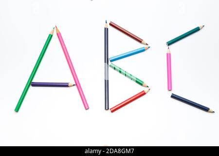 Lettres simples a, b et c faites de petits crayons de couleur sur fond blanc uniforme, chiffres simples faits de crayons, premiers chiffres à apprendre à l'école Banque D'Images