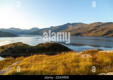 Lever du soleil sur le Loch Hourn près d'Arnisdale en regardant vers la région reculée de Knoydart, en Écosse. Banque D'Images