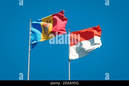 De magnifiques drapeaux nationaux de la Moldavie et de l'Indonésie réunis sur fond de ciel. Concept d'illustration 3D. Banque D'Images
