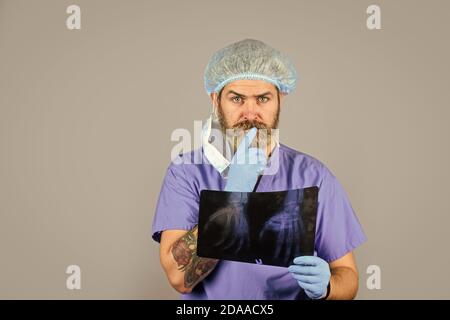 Fracture et dommages osseux. Le médecin compare les résultats. Rayonnement de rayons X. Le médecin possède des images d'os. Le médecin examine l'instantané radiographique du poignet. Le chirurgien estime les dommages. Urgence hospitalière. Banque D'Images