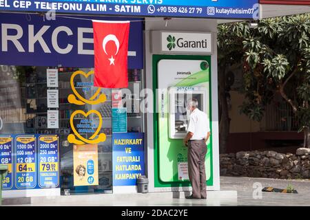 Antalya, Turquie - vers octobre, 2020: L'homme turc senior se tient près de ATM de la Garanti BBVA. Garanti Bank est la deuxième banque privée en Turquie Banque D'Images