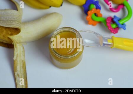 La nourriture pour bébés, la banane purée de pommes de terre et les bananes sur un fond blanc il est isolé. Banque D'Images