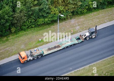 Chargement d'un tracteur sur une plate-forme de camion pour le transport de machines agricoles - Moscou, Russie, 24 août 2020 Banque D'Images