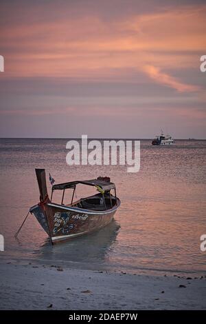 Koh Lipee, Thaïlande, février 2009. Hors-bord à la plage dans le parc marin national de Tarutao au coucher du soleil. Banque D'Images