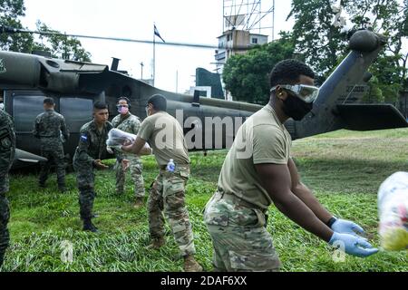 San Pedro Sula, Honduras. 11 novembre 2020. Les soldats de la Force opérationnelle interarmées des États-Unis-Bravo et l'armée hondurienne chargent des fournitures d'urgence dans un hélicoptère HH-60 Black Hawk de l'armée américaine pour livraison dans les régions touchées par l'ouragan ETA le 11 novembre 2020 à San Pedro Sula, au Honduras. Le puissant cyclone a tué au moins 50 personnes et dévasté certaines parties du Nicaragua et du Honduras. Credit: Planetpix/Alamy Live News Banque D'Images