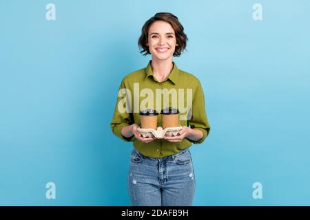 Photo portrait d'une femme tenant deux tasses de café support en carton isolé sur fond bleu clair pastel Banque D'Images