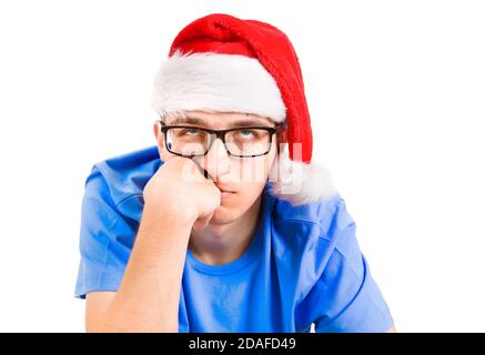 Sad Young en Santa Hat Portrait en gros plan sur le blanc Arrière-plan Banque D'Images