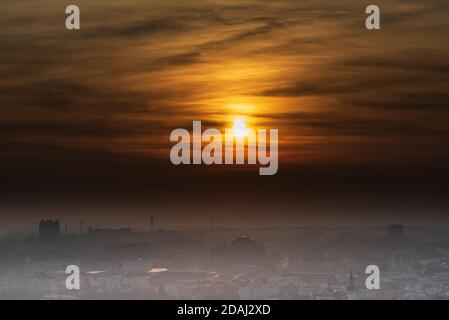 Soleil avec ciel coloré au-dessus de la ville d'Ostrava de Halda EMA colline en République tchèque pendant l'automne brumeux jour Banque D'Images