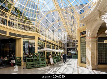 Restaurants et magasins dans le passage des Lions, passage piéton couvert d'un toit en verre dans le centre-ville de Genève. Banque D'Images