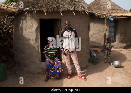 Village de Tanga, région de Selingue, Mali, 27 avril 2015 ; Mamadou Camara, 42, est un agriculteur. En tant que garçon de 12 ans, il vivait avec sa famille à Tangakoro, près de la rivière avant la construction du barrage. Ils ont été forcés de déménager dans le village de Tanga à cause du barrage. Il aimerait cultiver des légumes mais le sol est trop dur et rocailleux. Kadiatou Traure, sa femme, avec leur premier enfant. Elle attend bientôt un deuxième enfant. Banque D'Images