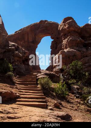 Un escalier menant à l'ouverture de l'arche de Turret, dans la section des fenêtres du parc national d'Arches, Utah, par une chaude journée ensoleillée Banque D'Images