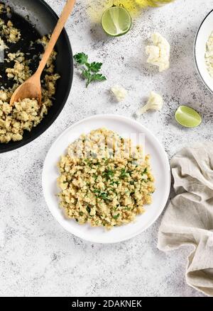 Riz au chou-fleur rôti sur fond de pierre légère. Vue de dessus, plan d'appartement Banque D'Images