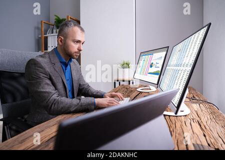 Employé analyste travaillant avec la feuille de calcul sur ordinateur Banque D'Images