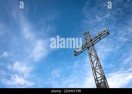 Croix de métal sur ciel bleu avec nuages, sommet de Corno d'Aquilio, plateau de Lessinia (Altopiano della Lessinia), Parc naturel régional, Vérone, Italie. Banque D'Images