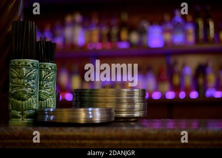 Vue depuis le bar, sur les étagères, sur lesquelles il y a deux piles de plaques métalliques de plateaux et un support avec tubes à boissons. Banque D'Images