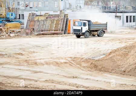 Camion-benne pour exploitation minière lourde de plusieurs tonnes chargé de cargaison lors de l'enlèvement du sol de construction du chantier. Concept de transport Banque D'Images