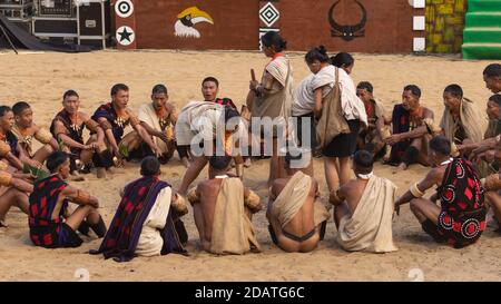 Naga hommes assis et les femmes folkloriques exécutant un traditionnel Rituel tribal au Nagaland Inde pendant le festival du charme le 4 Décembre 2016 Banque D'Images