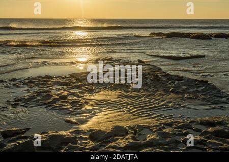 La côte à Dunraven Bay sur la côte du patrimoine de Glamourgan au coucher du soleil, dans la vallée de Glamourgan, au sud du pays de Galles. Banque D'Images