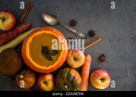 Soupe de museau rôtie dans un bol de potiron. Arrière-plan gris avec espace de copie. Idées de menu pour Thanksgiving. Banque D'Images