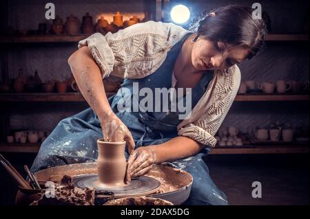 Cours de maître sur la modélisation de l'argile sur une roue de potier dans l'atelier de poterie. Banque D'Images