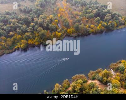 Un coup d'avion sur un bateau de pêcheur à moteur flotte dans les plaines inondables Rivière Dnieper près de Kherson au début de l'automne Banque D'Images