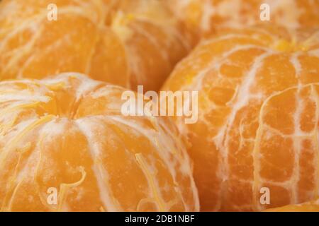 Beaucoup de tangerines non pelées en gros plan. Super macro. Banque D'Images